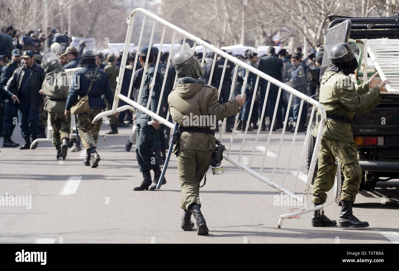 Iranian riot police carry barricades during a demonstration in front of the French Embassy to support Iran's nuclear program and to protest a Danish newspaper cartoon that is being perceived as an insult to the Prophet Mohammed in Tehran, Iran, February 12, 2006.  (UPI Photo/Mohammad Kheirkhah) Stock Photo