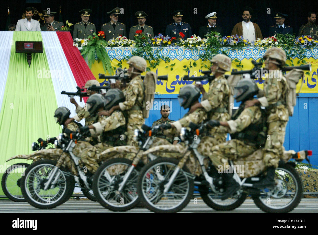 Iranian armed forces ride motorbikes as Iran's president Mahmoud Ahmadinejad (L) watches during Iran's army day in front of the mausoleum of the late revolutionary founder Ayatollah Ruhollah Khomeini, just outside Tehran, Iran, April 18, 2006. (UPI Photo/Mohammad Kheirkhah) Stock Photo