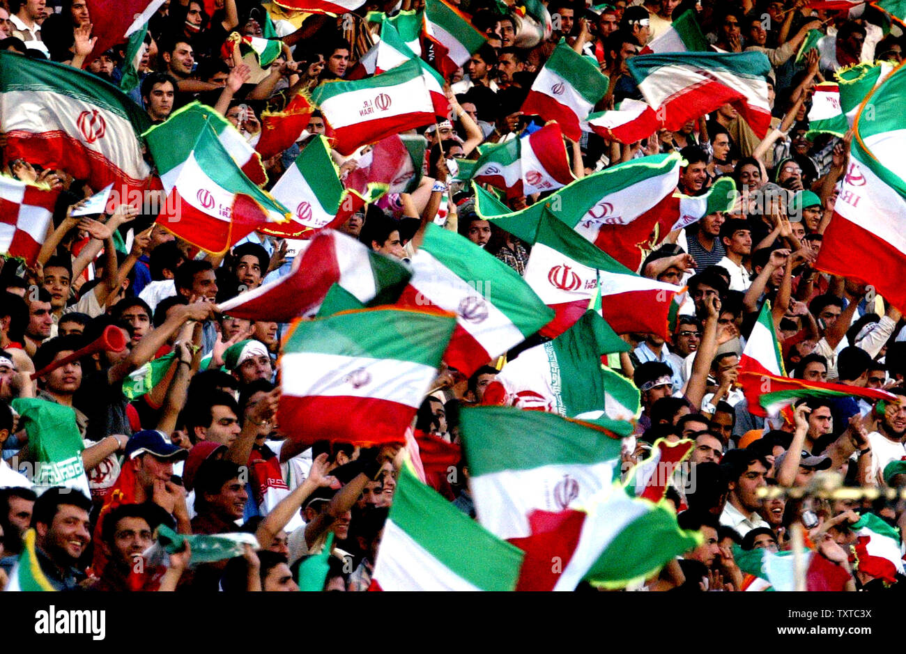 Iranian fans celebrate before a friendly match between Iran and Bosnia in Azadi (freedom) sport complex in Tehran, Iran, May 31, 2006. Iran won 5-2. (UPI Photo/Mohammad Kheirkhah) Stock Photo