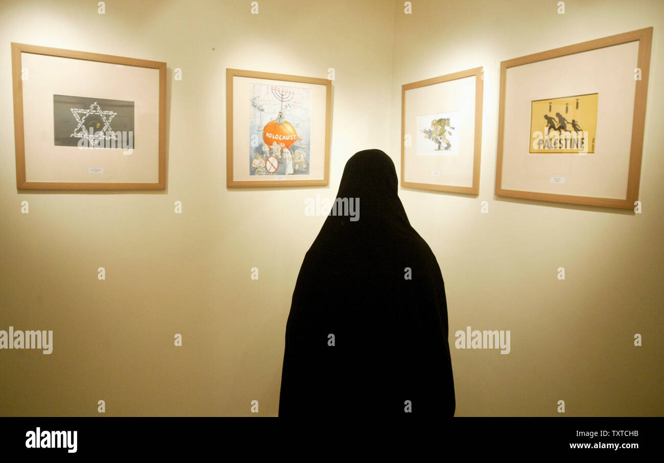 An Iranian woman visit the Holocaust International Cartoon contest exhibition in Tehran, Iran on August 14, 2006. The contest is sponsored by Tehran's Hamshahri Newspaper and is aimed at testing how committed Europeans were to the concept freedom of expression. This contest comes months after a Danish paper published satirical cartoons of the Islamic Prophet Muhammad. (UPI Photo/Mohammad Kheirkhah) Stock Photo