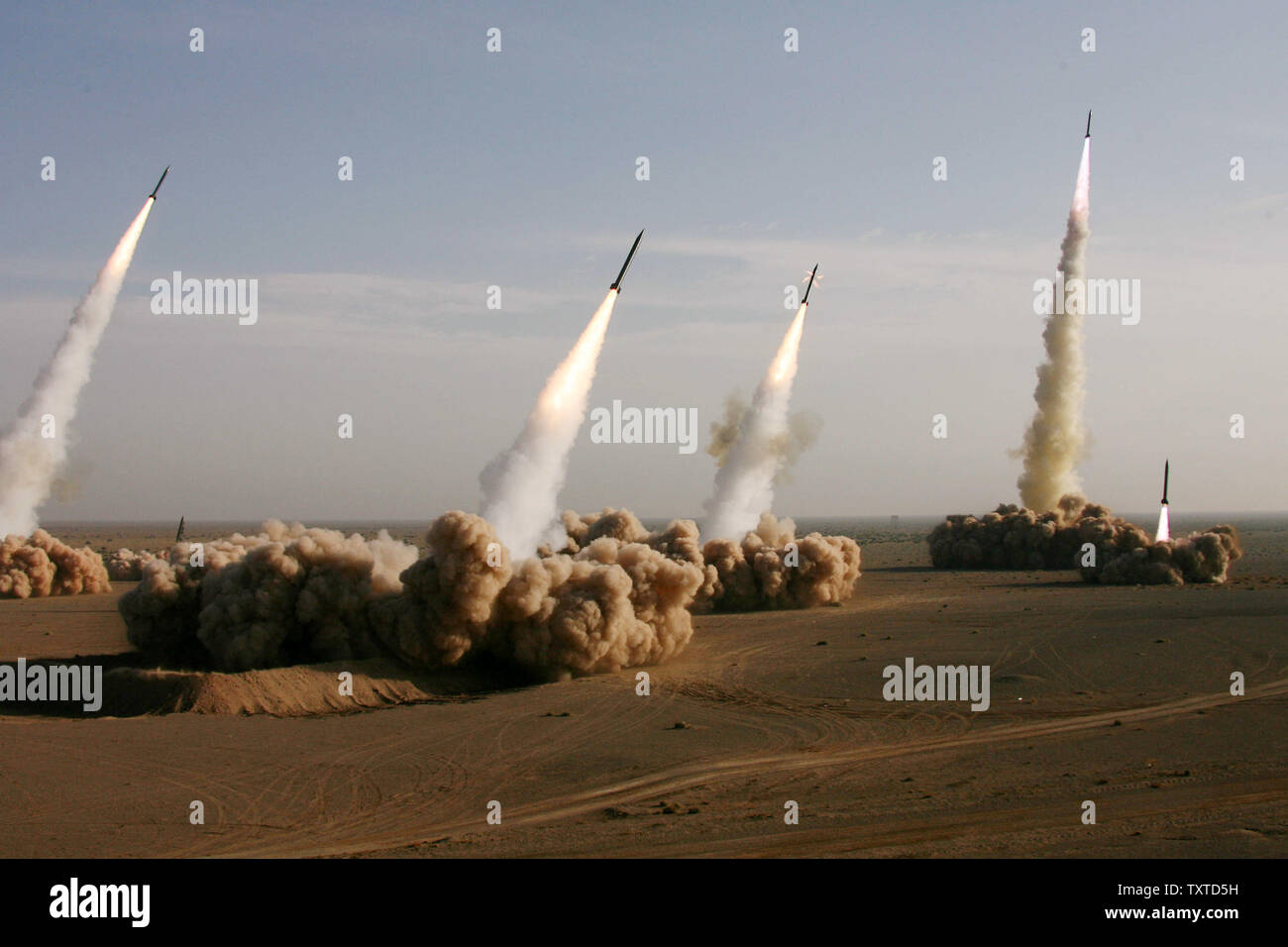 Iranian missiles are launched during a military maneuver dubbed 'al-Tasoul al-Aazam,' or Greater Prophet, in a desert near the holy city of Qom 80 miles (130 kilometers) south of Tehran on November 2, 2006. During the 10-day maneuvers across several parts of Iranian territory, the Gulf waters, and the Sea of Oman, the Iranian Revolutionary Guards will test long-range Shahab-2 and Shahab-3 ballistic missiles carrying cluster heads and new types of torpedoes fired by submarines and military vessels. The Iranian exercises follow similar maneuvers in Gulf waters by the United States and five other Stock Photo