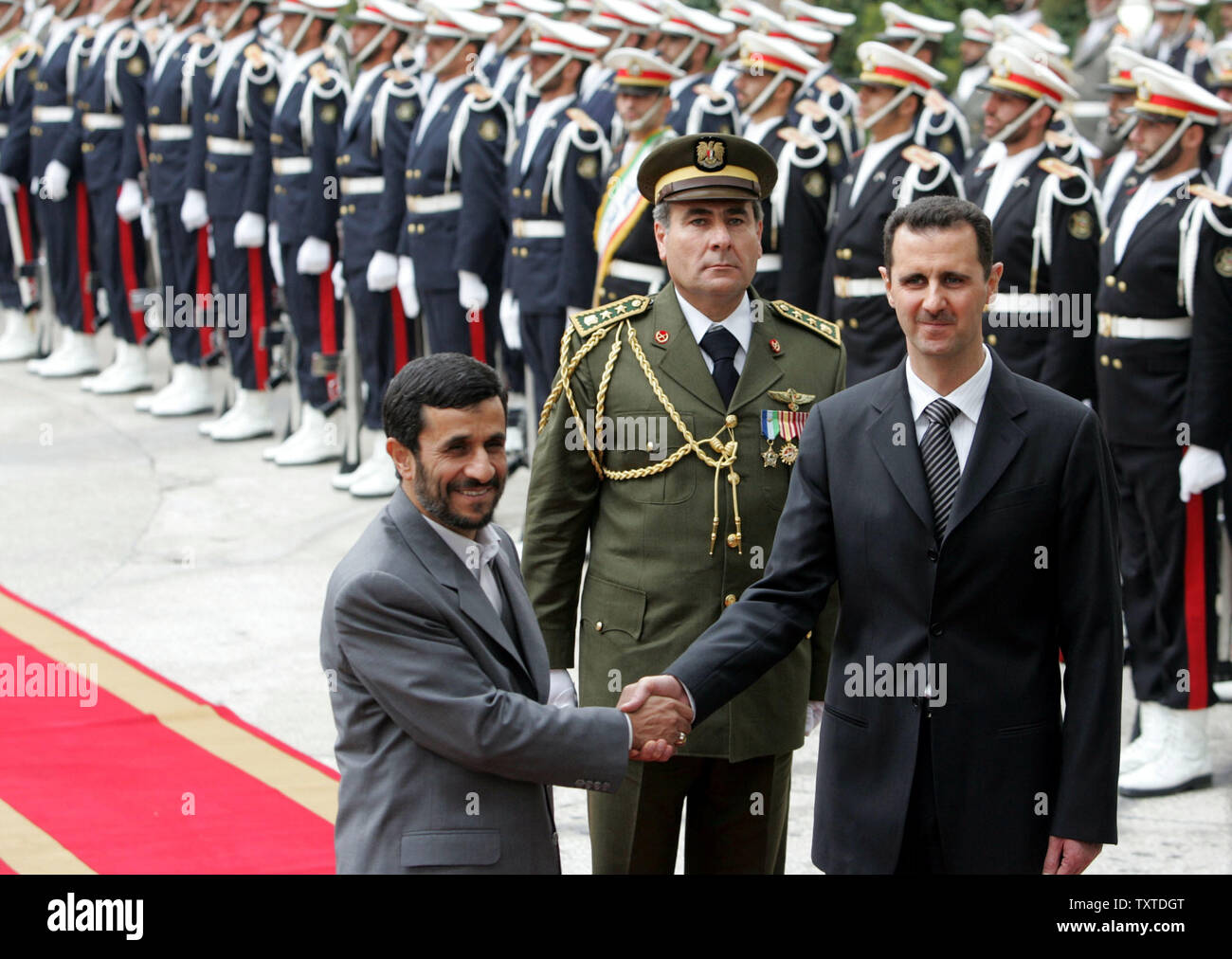 Iranian president Mahmoud Ahmadinejad (L) shakes hands with his Syrian counterpart Bashar Al-Assad (R) at the presidential palace in Tehran on February 17, 2007.  (UPI Photo) Stock Photo