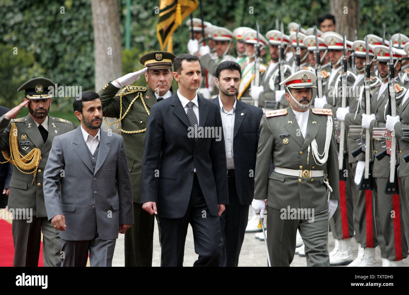 Iranian president Mahmoud Ahmadinejad (L) walks with his Syrian counterpart Bashar Al-Assad (R) during a welcome ceremony at the presidential palace in Tehran on February 17, 2007.  (UPI Photo) Stock Photo