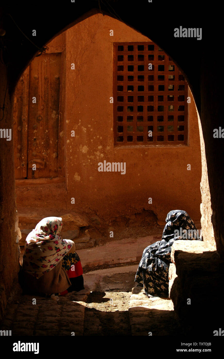 Iranian women talk together as they rest near their home in Abyaneh village near the city of Kashan in Isfahan Province 232.5 miles (375 km) southeast of Tehran on March 8, 2007. The village is one of the oldest in Iran, attracting numerous native and foreign tourists year-round, and has been called an entrance to Iranian history. (UPI Photo) Stock Photo