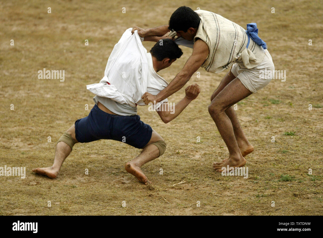 Iranian wrestlers fight during a traditional form of wrestling called Bachokheh on the last day of Nowrouz being held for over 100 years in the city of Esfarayen in north Khorasan province 733Km (425 miles) northeast of Tehran on April 5, 2007. (UPI Photo) Stock Photo