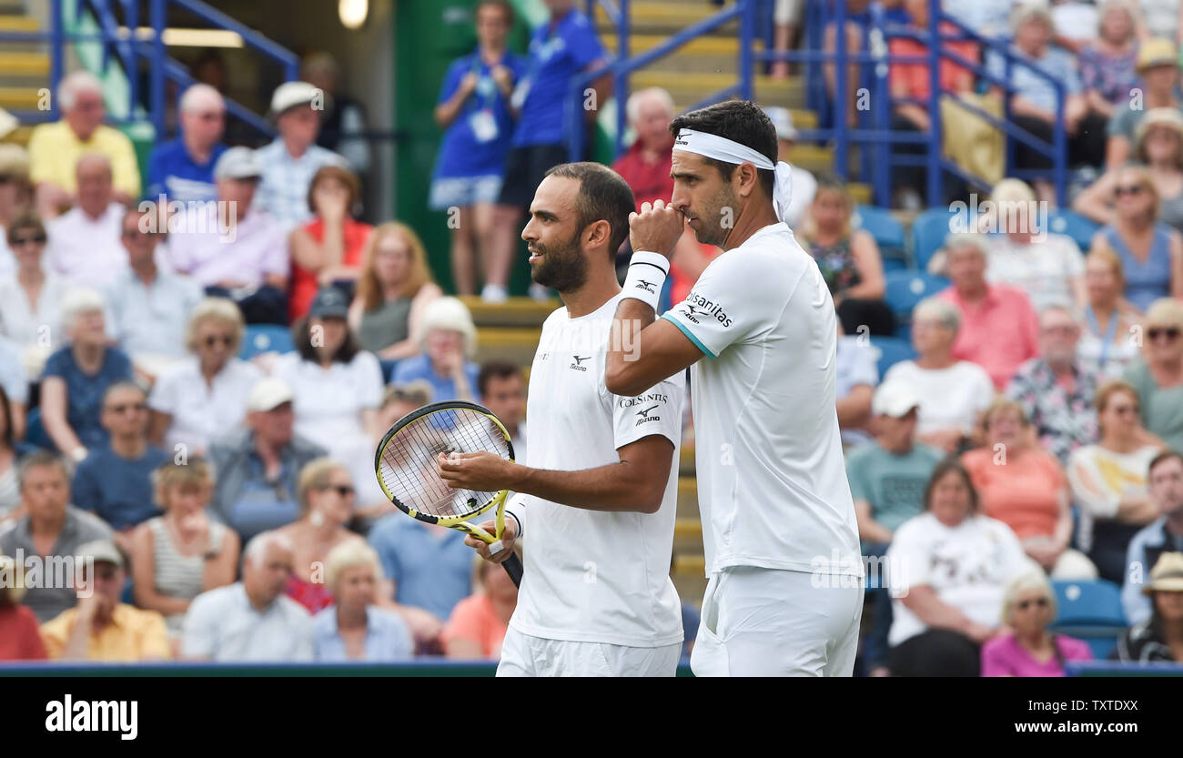 Eastbourne, UK. 25th June, 2019. Juan Sebastien Cabal (left) and Robert Farah of Colombia discuss tactics against Andy Murray and Marcelo Melo during their doubles match at the Nature Valley International tennis tournament held at Devonshire Park in Eastbourne . Credit: Simon Dack/Alamy Live News Stock Photo