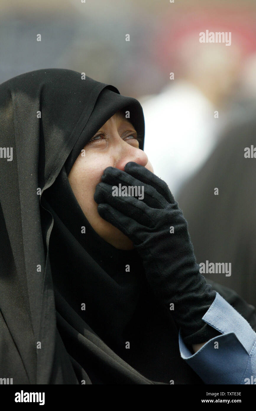 An Iranian woman cries to mourn the death of Fatima Zahra, daughter of