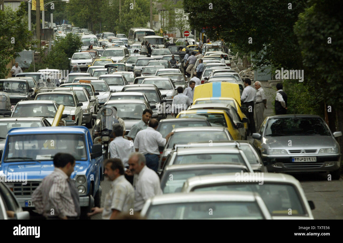 Iranians wait in line for gasoline in Tehran on June 27, 2007. Iran, the world's second-largest oil exporter, will begin gasoline rationing for private vehicles yesterday to rein in consumption and cut expensive gas imports. Iranians set fire to a dozen gas stations in the capital early Wednesday and smashed windows, angered by the sudden start of fuel rationing, a step that threatens to further increase the unpopularity of hard-line President Mahmoud Ahmadinejad. (UPI Photo/Mohammad Kheirkhah) Stock Photo