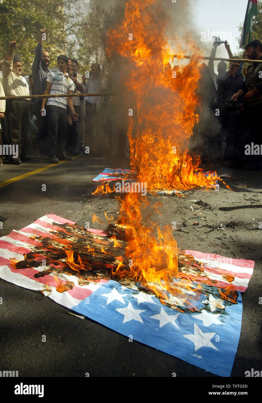 Iranians burn U.S. and British flags as they attend a rally on Al-Quds day (Jerusalem Day) in Tehran, Iran on September 27, 2008.  Jerusalem Day, an annual day of protest decreed in 1979 by the Iran's late revolutionary founder Ayatollah Ruhollah Khomeini , saw people across the Middle East demand that the holy city be returned to Palestinian control. (UPI Photo/Mohammad Kheirkhah) Stock Photo