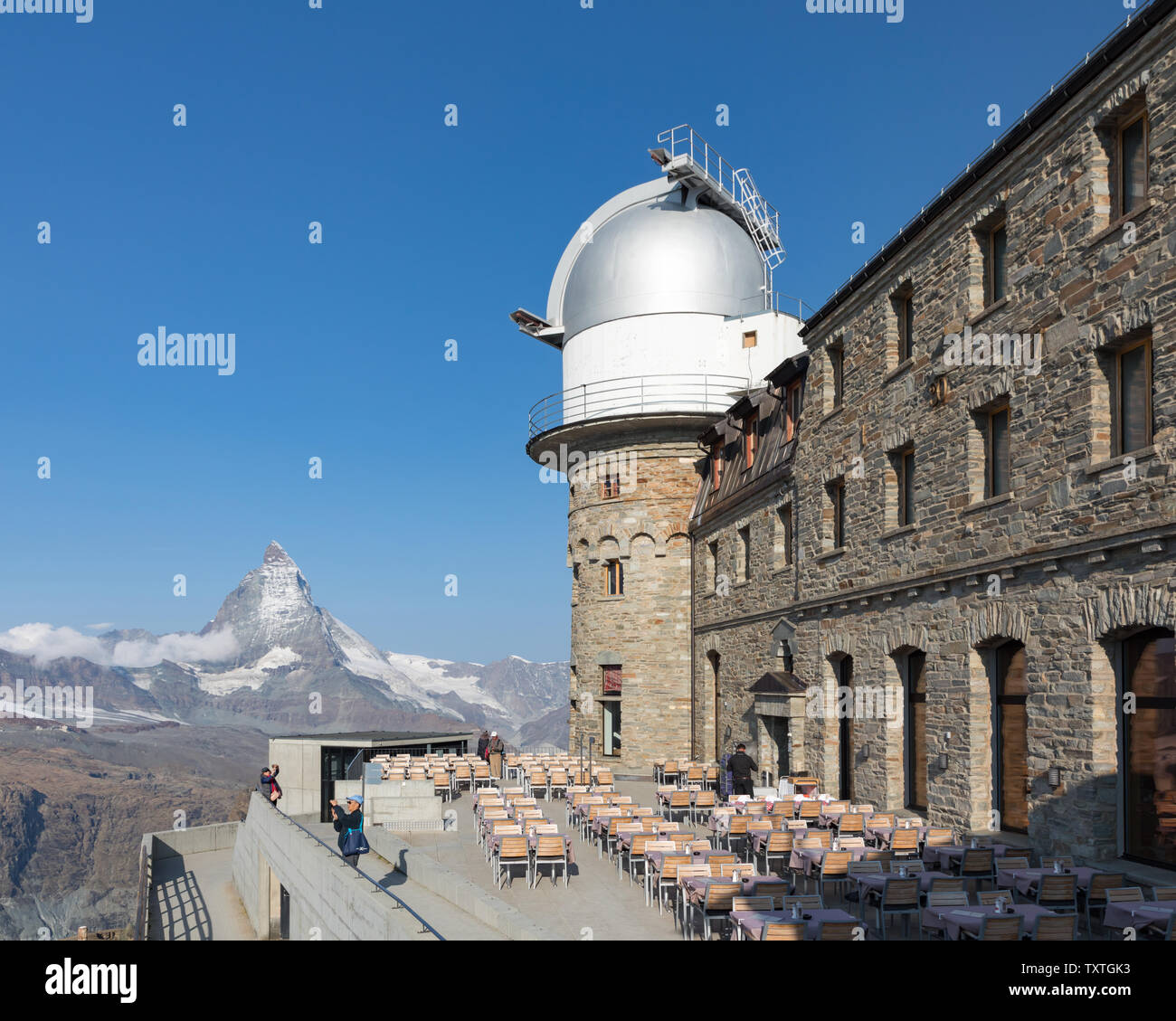 Gornergrat, Valais, Switzerland: beneath an astronomical observatory dome is the terrace of the Kulmhotel, Europe's highest restaurant at 3100m. Stock Photo