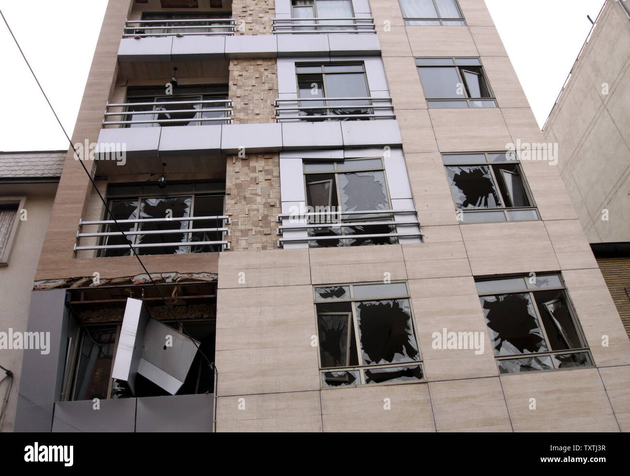 Shattered windows mark the scene of a bombing in northern Tehran, Iran ...