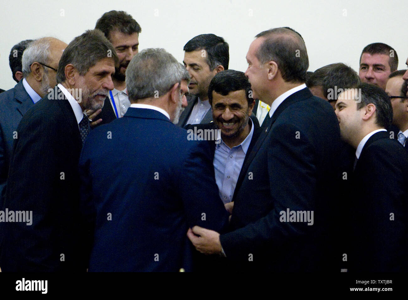 Iranian President Mahmoud Ahmadinejad (C) and Turkish and Brazilian counterparts celebrate after the three countries signed an agreement to ship Iran's low-enriched uranium to Turkey in exchange for fuel for a nuclear reactor in Tehran, Iran, on May 17, 2010. Iran signed an agreement to swap its uranium in Turkey for enrichment, hoping to avert new international sanctions. Brazil helped broker the deal.     UPI/Maryam Rahmanian Stock Photo