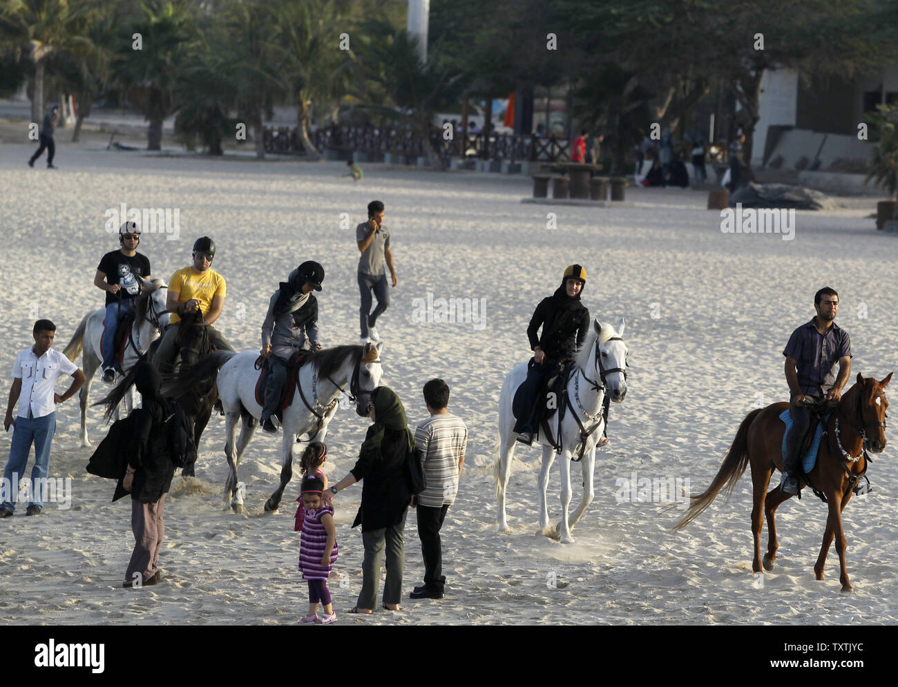 Iranian ride horses on a beach on Kish Island in southern Iran on April ...