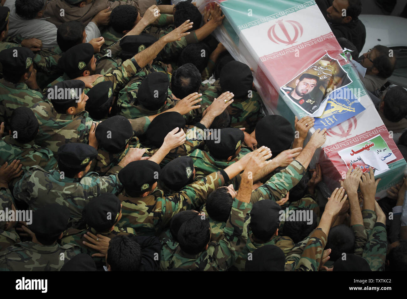 Iranians carry the flag draped coffins containing the remains of a  Revolutionary Guard soldiers  who were killed in explosion in Bidegeneh village, about 35 Kilometers (21 miles) west of Tehran. The explosion happened on Saturday when  a munitions depot caught fire at the IRGC base in Bidgeneh village. The Total of 17 IRGC forces, including Maj. Gen. Hassan Tehrani Moqaddam, director of the Guard's Jihad Self-Sufficiency Organization were killed and 16 others were seriously injured. Tehran, Iran , November 14, 2011.     UPI/Maryam Rahmanian. Stock Photo