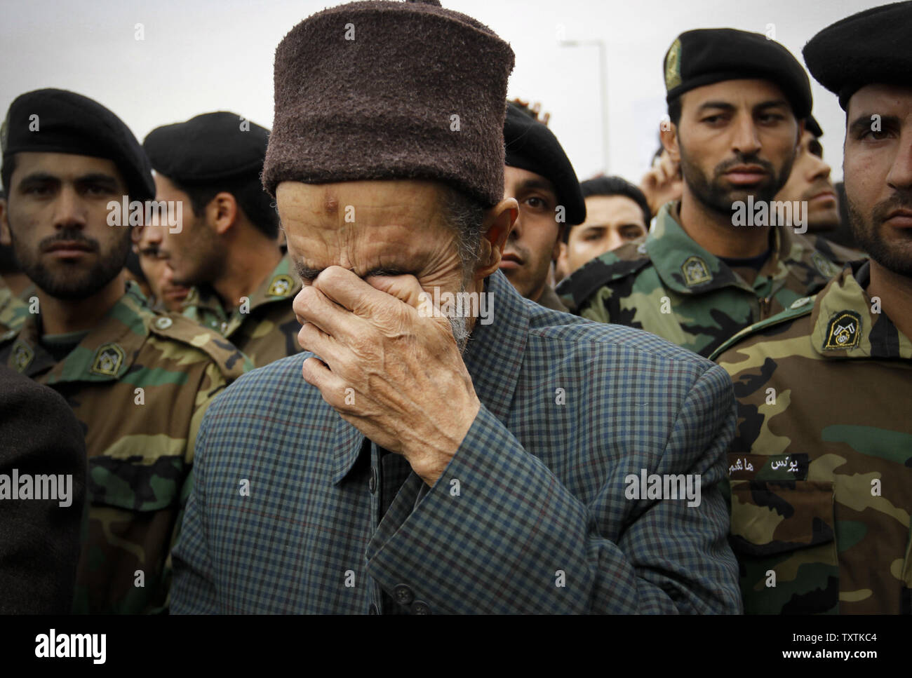 An Iranian man mourn for Revolutionary Guard soldiers who killed during explosion in Tehran, Iran, November 14, 2011.The explosion happened on on Saturday when  a munitions depot caught fire at the IRGC base in Bidgeneh village. The Total of 17 IRGC forces, including Maj. Gen. Hassan Tehrani Moqaddam, director of the Guard's Jihad Self-Sufficiency Organization were killed and 16 others were seriously injured. Tehran, Iran , November 14, 2011.     UPI/Maryam Rahmanian. Stock Photo