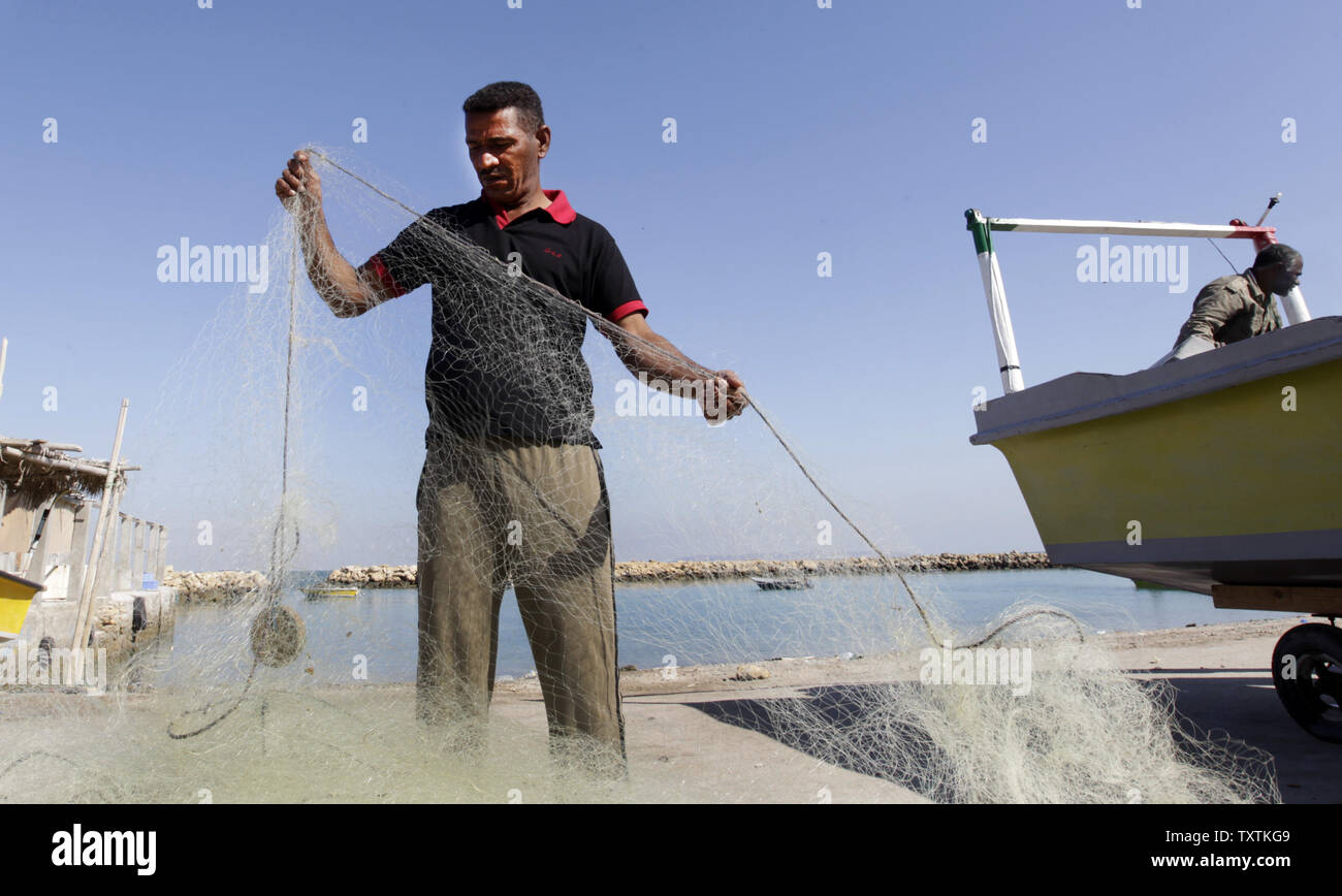 An Iranian fisher cleans his  fishing net on the Iranian Qeshm Island  on December 24, 2011. Qeshm Island is located at southern part of Iran in the Hormoz Strait.     UPI/Maryam Rahmanian Stock Photo