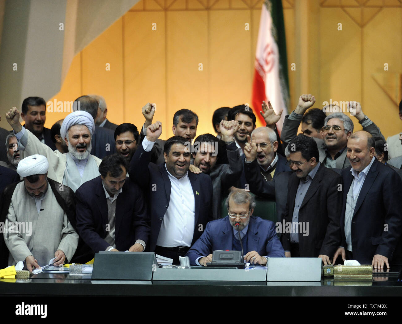 Iranian Parliamentary speaker Ali Larijani (C) delivers the result of the impeachment of the labor minister Abdolreza Sheikholeslami, unseen, at the parliament in Tehran, Iran on February 3, 2013. Out of 272 lawmakers in the parliament on Sunday, 192 voted against the labor minister. The main reason behind the MP's decision to dismiss the minister was Sheikholeslami's refusal  to remove former Tehran prosecutor general Saeed Mortazavi from his post as the director of the Social Security Organization.     UPI/Maryam Rahmanian Stock Photo
