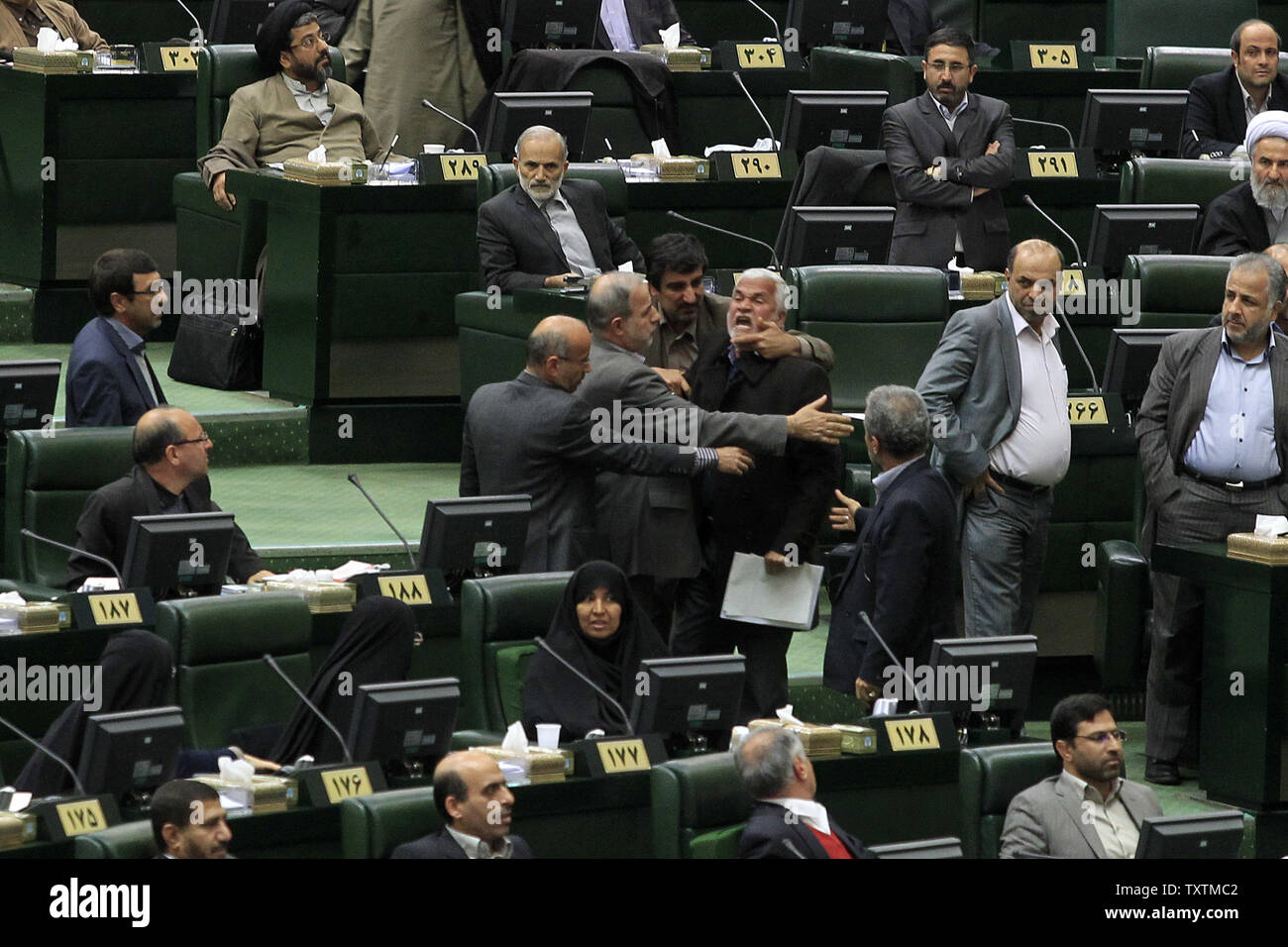 A member of the Iranian parliament protests while Iranian President Mahmoud Ahmadinejad (unseen) speaks during the impeachment of the labor minister Abdolreza Sheikholeslami, unseen, at the parliament in Tehran, Iran on February 3, 2013. Out of 272 lawmakers in the parliament on Sunday, 192 voted against the labor minister. The main reason behind the MP's decision to dismiss the minister was Sheikholeslami's refusal  to remove former Tehran prosecutor general Saeed Mortazavi from his post as the director of the Social Security Organization.     UPI/Maryam Rahmanian Stock Photo