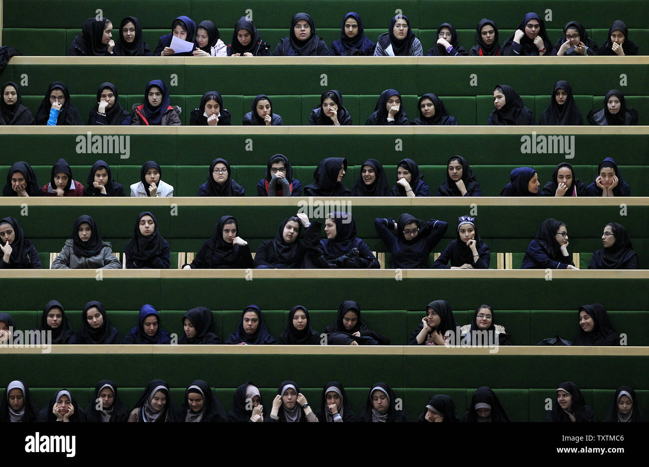 School girls listen to Iranian President Mahmoud Ahmadinejad (Not Pictured)  during the impeachment of the labor minister Abdolreza Sheikholeslami at the parliament in Tehran, Iran on February 3, 2013. Out of 272 lawmakers in the parliament on Sunday, 192 voted against the labor minister. The main reason behind the MP's decision to dismiss the minister was Sheikholeslami's refusal  to remove former Tehran prosecutor general Saeed Mortazavi from his post as the director of the Social Security Organization.     UPI/Maryam Rahmanian Stock Photo