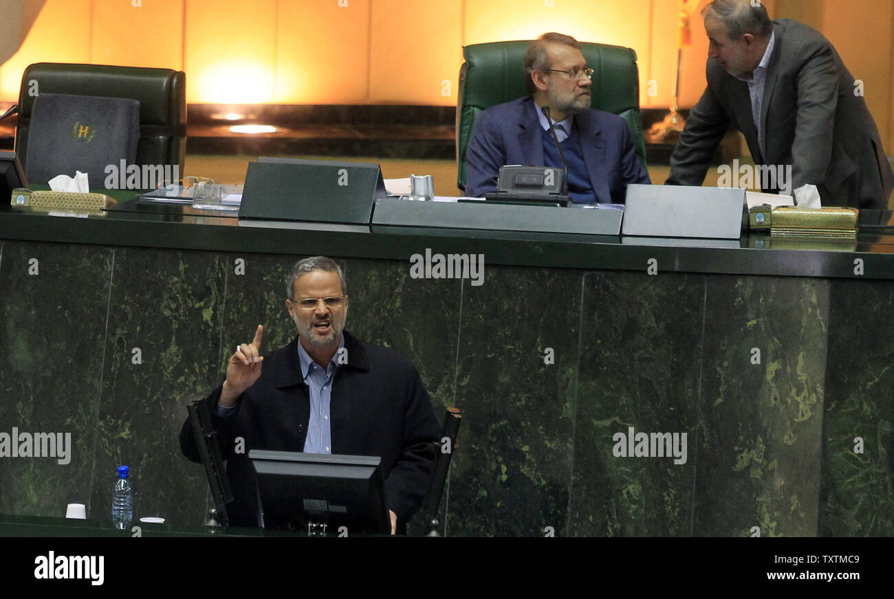 Iranian Labor Minister Abdolreza Sheikholeslami speaks as Parliamentary Speaker Ali larijani (C) speaks to a lawmaker during Sheikholeslami's impeachment at the  parliament in Tehran, Iran on February 3, 2013. Out of 272 lawmakers in the parliament on Sunday, 192 voted against the labor minister. The main reason behind the MP's decision to dismiss the minister was Sheikholeslami's refusal  to remove former Tehran prosecutor general Saeed Mortazavi from his post as the director of the Social Security Organization.     UPI/Maryam Rahmanian Stock Photo