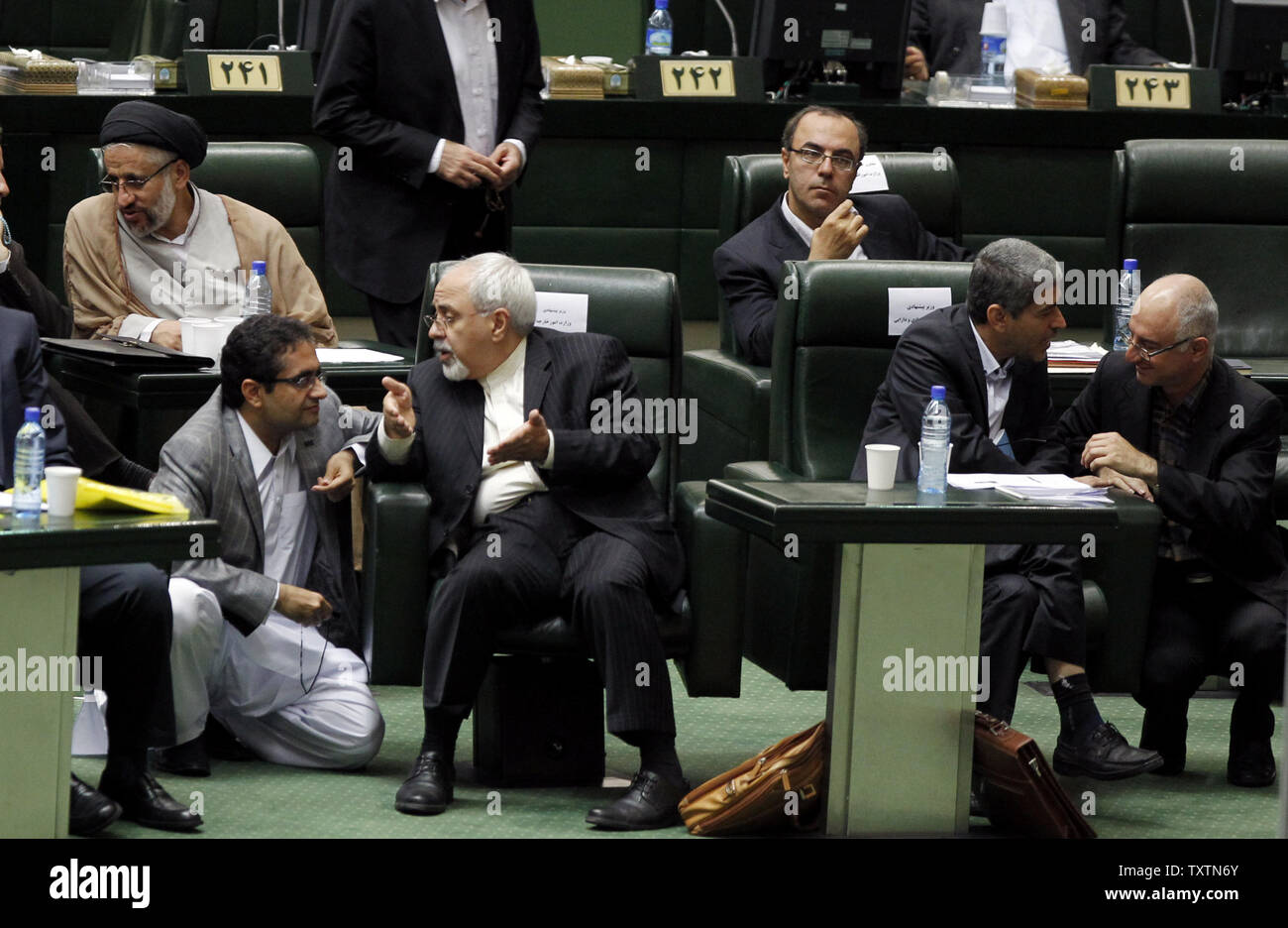 Nominated Iranian Minister of Foreign Affairs Mohammad Javad Zarif (2nd-L) speaks to a lawmaker in parliment on the second day of debate over President Hassan Rouhani's proposed cabinet ministers on August 13, 2013 in Tehran, Iran. All nominated ministers need the majority vote of the 290 deputies before taking office.     UPI/Maryam Rahmanian Stock Photo
