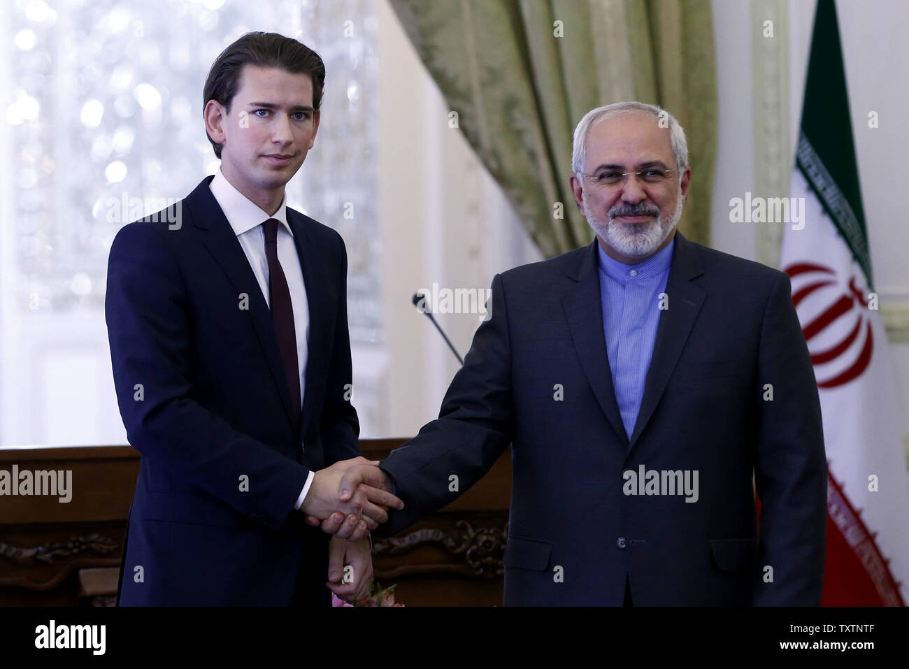 Iranian Foreign Minister Mohamad Javad Zarif  (R) shakes hands with his Austrian counterpart Sebastian Kurz (L) after their joint press conference  in Tehran, Iran, April 27, 2014. Austria’s President Heinz Fischer is expected to pay a visit to Iran in the near future, first head of a western state to visit Iran for many years.  UPI/Maryam Rahmanian Stock Photo