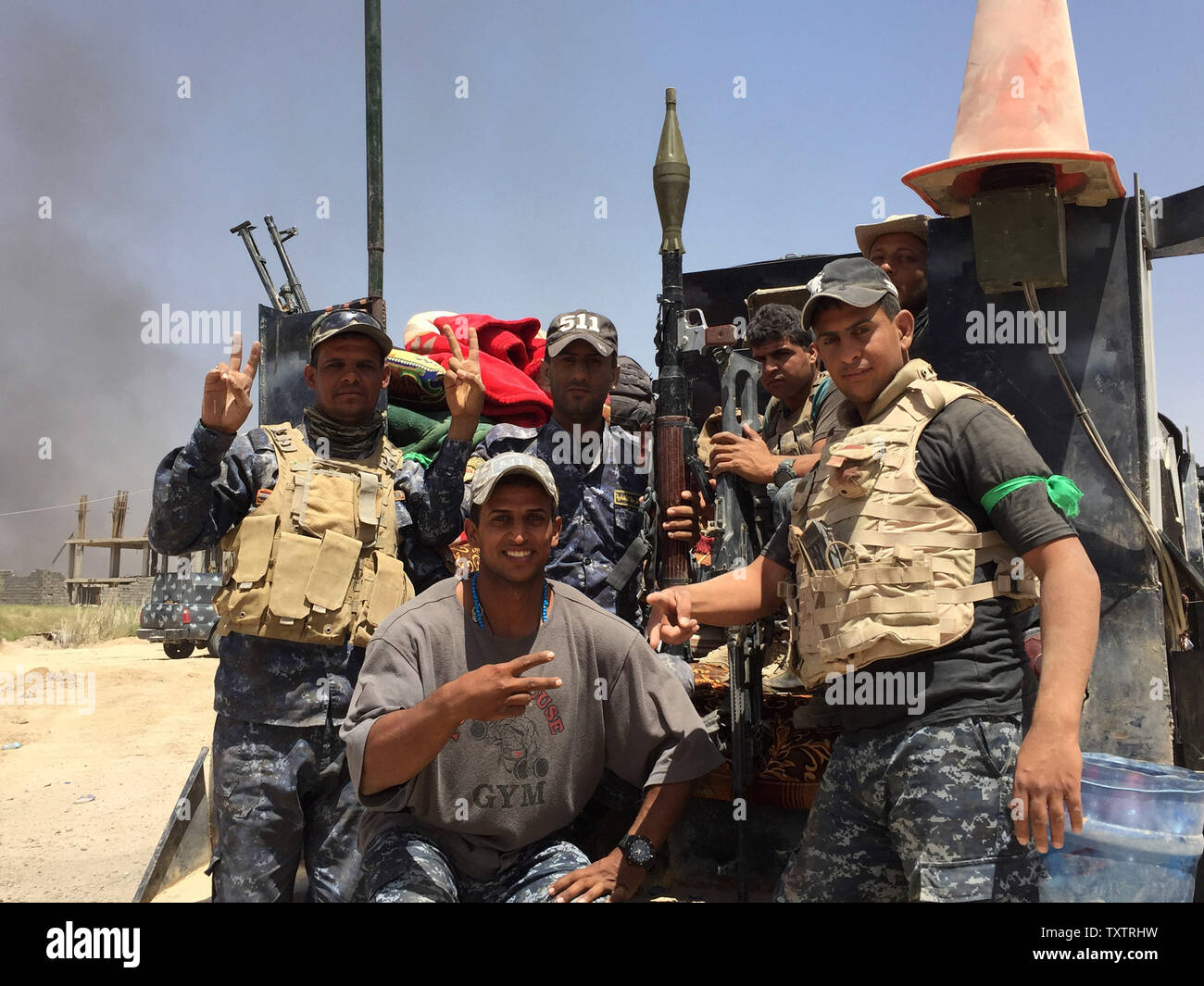 Soldiers of Iraqi government forces flashes victory signs after recapturing the town Zankoura from the Islamic State (IS) jihadist group, northwest of Ramadi, in Anbar province, Iraq on June 16, 2016. Retaking the area around Zankoura was an attempt by IS to distract Iraqi forces in Anbar province, where a big battle to retake Fallujah is going on.      Photo by Abbas Mohammed /UPI Stock Photo