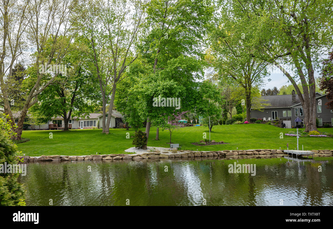 Canton, Ohio lake, USA. May 7, 2019. Waterfront holiday homes, green