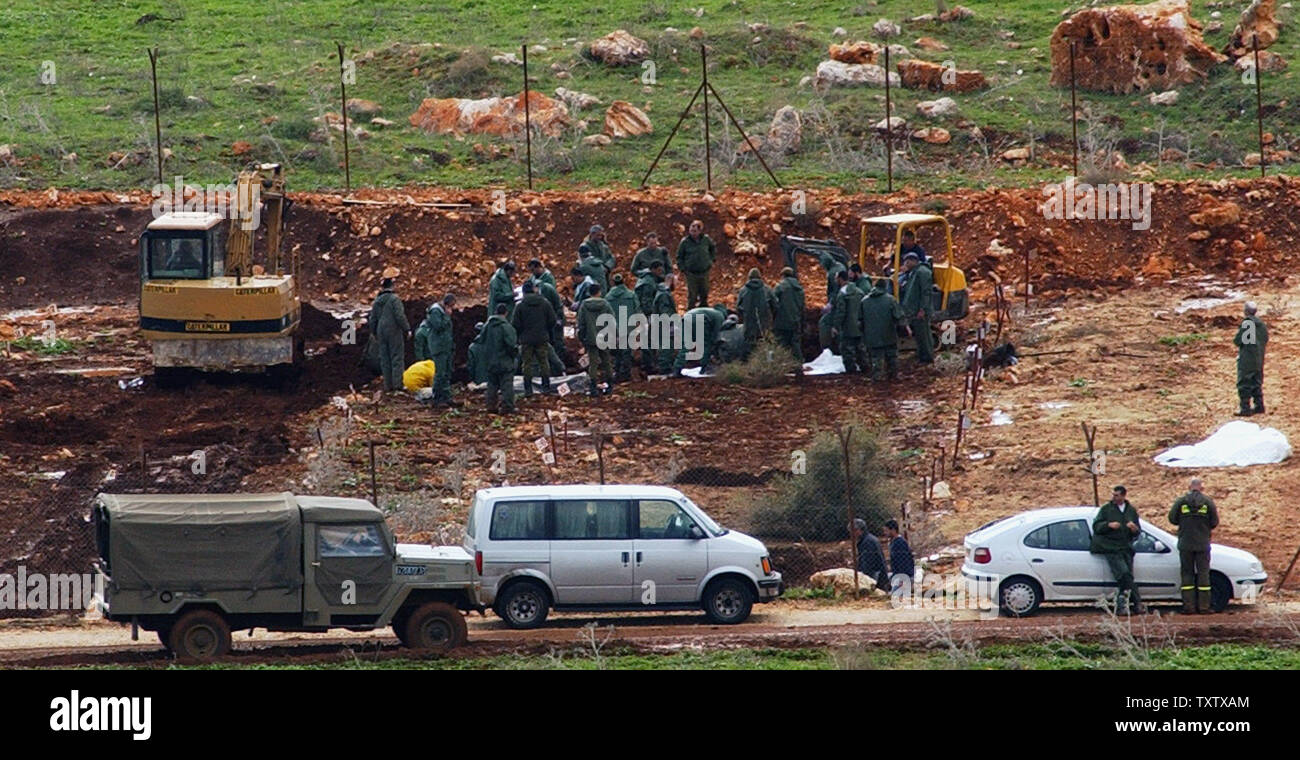 The Israeli army exhumes the bodies of Hizbollah militants in a graveyard in Amiad, in northern Israel, January 27, 2004, in preparation for the completion of a controversial prisoner exchange. In a prisoner swap brokered by Germany, Israel will receive the bodies of three slain Israeli soldiers and an Israeli businessman in exchange for releasing 59 bodies of Hizbollah fighters and more than 400 Arab prisoners. (UPI Photo/Debbie Hill) Stock Photo