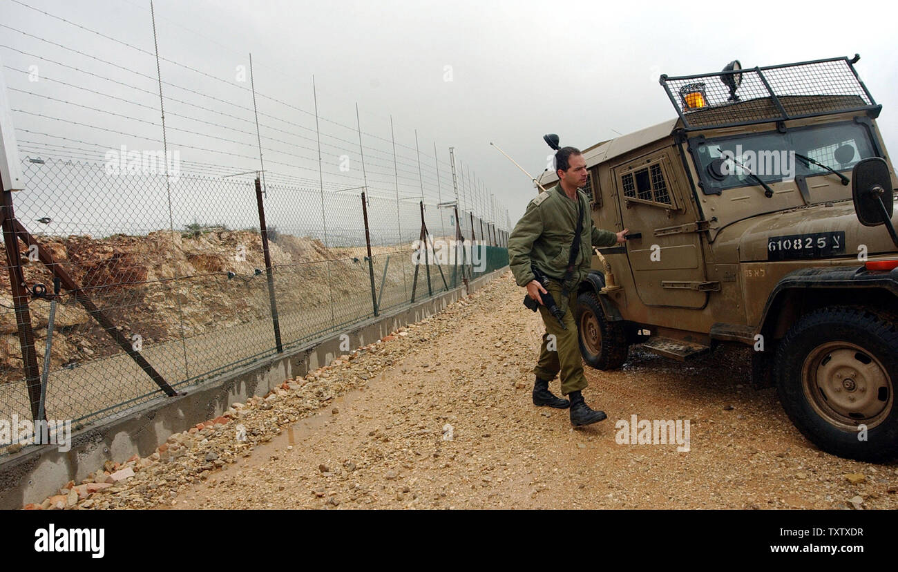 An Israeli soldier gets out of an army jeep beside the Israeli