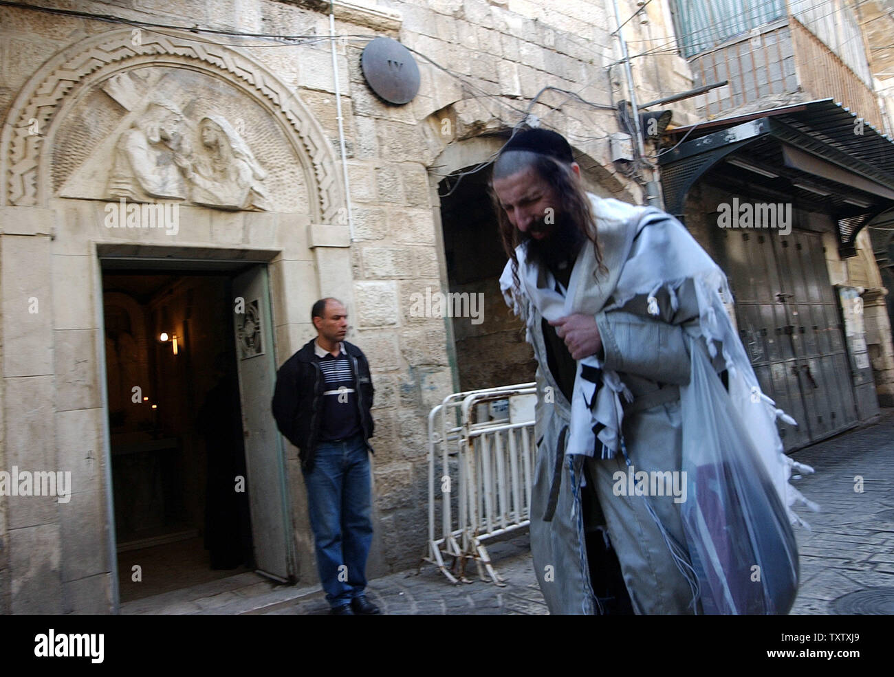 An Ultra Orthodox Jews Walks By The Third Station Of The Cross On The