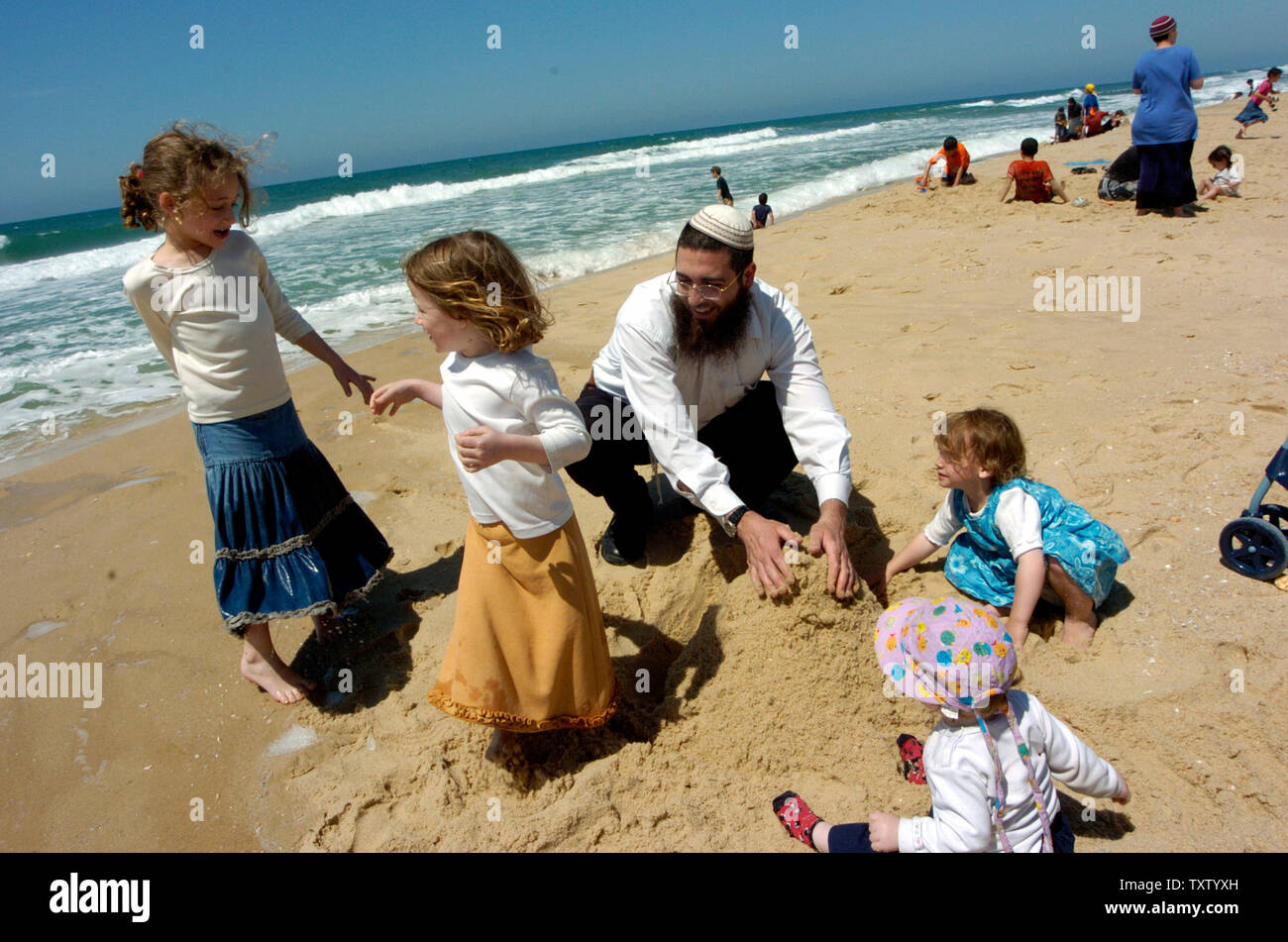 Israeli settlers enjoy the beach in the Gush Katif Settlement, Shirat Hayam, in the Gaza Strip, April 26, 2005. Israelis are visiting the Gush Katif settlements during the Passover holiday to show support to the Gaza settlers against the upcoming disengagement. (UPI Photo/Debbie Hill) Stock Photo