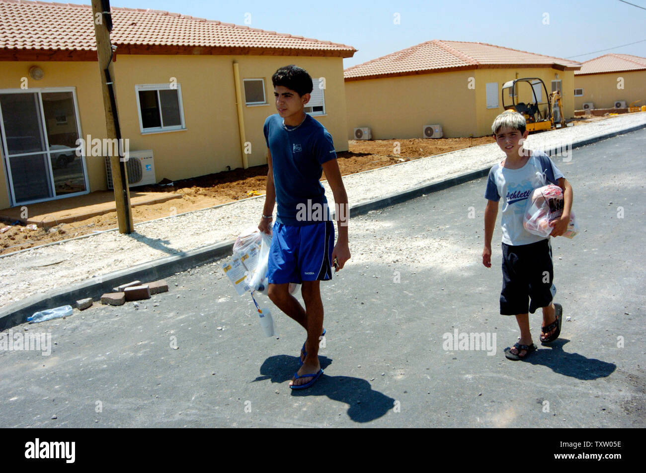 Israeli settler boys from Nisanit in the Gaza Strip, walk by new mobile home in Nitzan, in southern Israel, August 1, 2005.  The temporary housing is provided  by the government for Israeli settlers who want to move before the upcoming disengagement from the Gaza Strip. Israeli Prime Minister Ariel Sharon said that over half of the eligible residents of the Gaza Strip have filled out applications to receive compensation from the disengagement authority. (UPI Photo/Debbie Hill) Stock Photo
