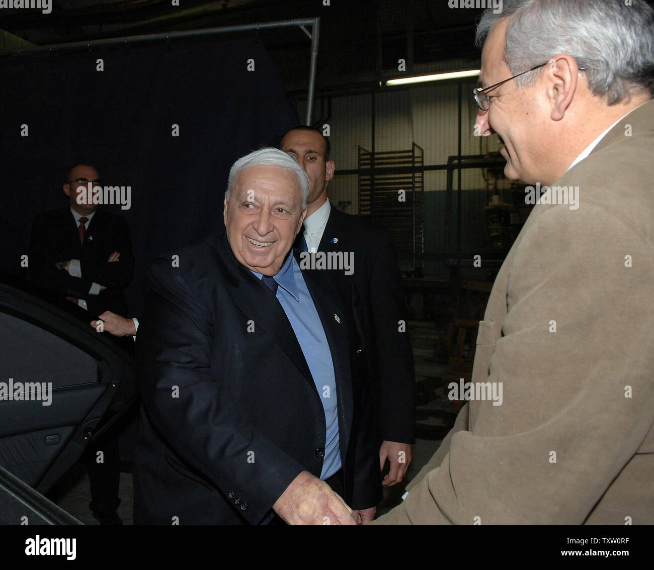 Israeli Prime Minister Ariel Sharon greets Professor Shlomo Mor Yosef, Director General of Hadassah University Medical Center  as he leaves Hadassah Hospital in Jerusalem, December 20, 2005. Prime Minister Sharon left the hospital after being treated for a mild stroke and said he is in a hurry to get back to work. (UPI Photo/ GPO Avi Ohayon) Stock Photo