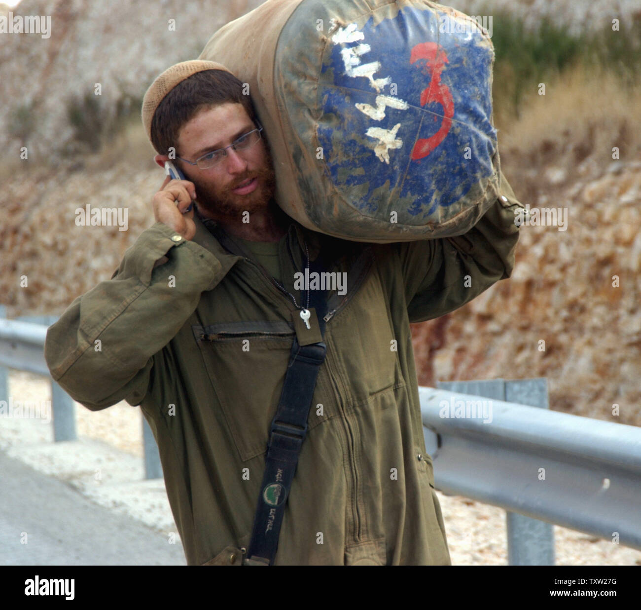 An Israeli soldier phones home near the Israeli-Lebanese border after returning from southern Lebanon, after a U.N. drafted cease-fire went into effect, August 14, 2006. The cease-fire between Hezbollah and Israel took effect early Monday in an attempt to end a month of violence. (UPI Photo/Debbie Hill) Stock Photo