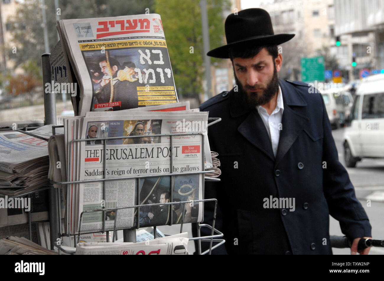 An Orthodox Jew walks by Israeli newspapers in downtown Jerusalem announcing the execution of former Iraqi President Saddam Hussein, December 31, 2006.  (UPI Photo/Debbie Hilll) Stock Photo