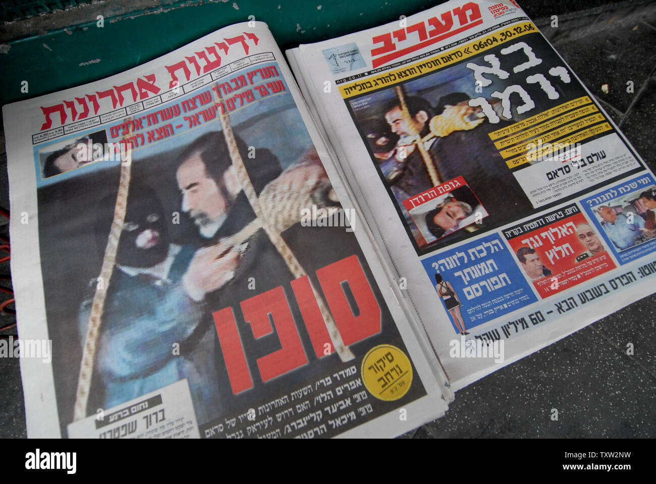 Israelis walks by newspapers in downtown Jerusalem announcing the execution of former Iraqi President Saddam Hussein, December 31, 2006.  (UPI Photo/Debbie Hilll) Stock Photo