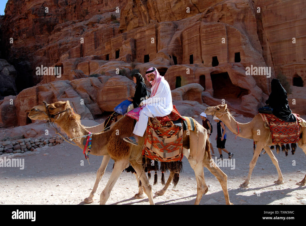 Arab tourists ride camels in Petra, Jordan, August 6, 2007. Petra is the  remains of a city carved out of the rock in southern Jordan by the  Nabataean Arabs. It was voted