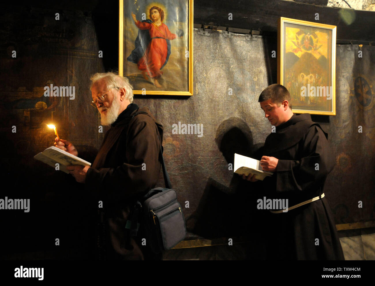 Catholic priests pray in the grotto of the Church of Nativity, where
