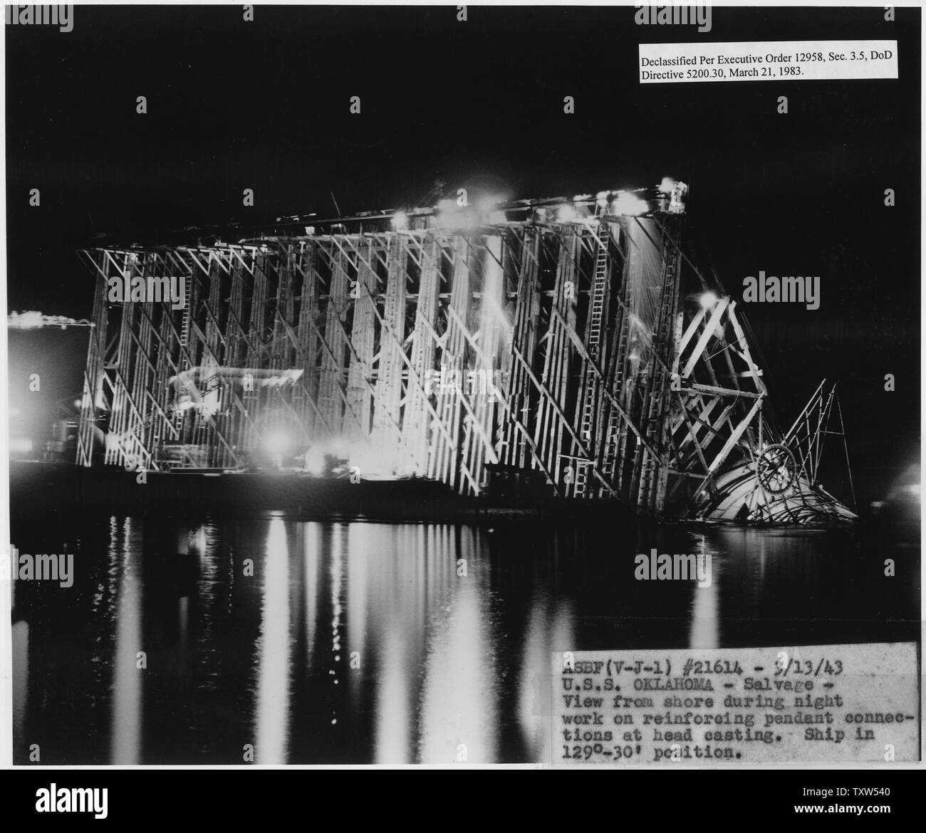 ASBF (V-J-1) #21614, 3/13/43; USS Oklahoma- Salvage- View from shore during night work on reinforcing pendant connections at head casting. Ship in 129 degees-30' position; Scope and content:  This is one of a collection of photographs of salvage operations at Pearl Harbor Naval Shipyard taken by the shipyard during the period following the Japanese attack on Pearl Harbor which initiated US participation in World War II. The photographs are found in a number of files in several shipyard records series. Stock Photo