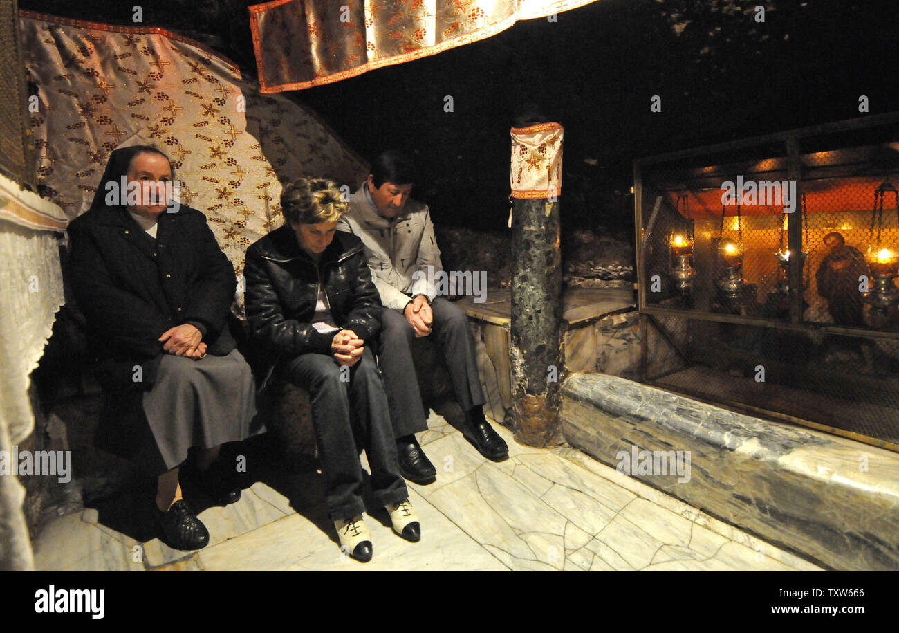 Christians pray in the grotto in the Church of Nativity in the biblical