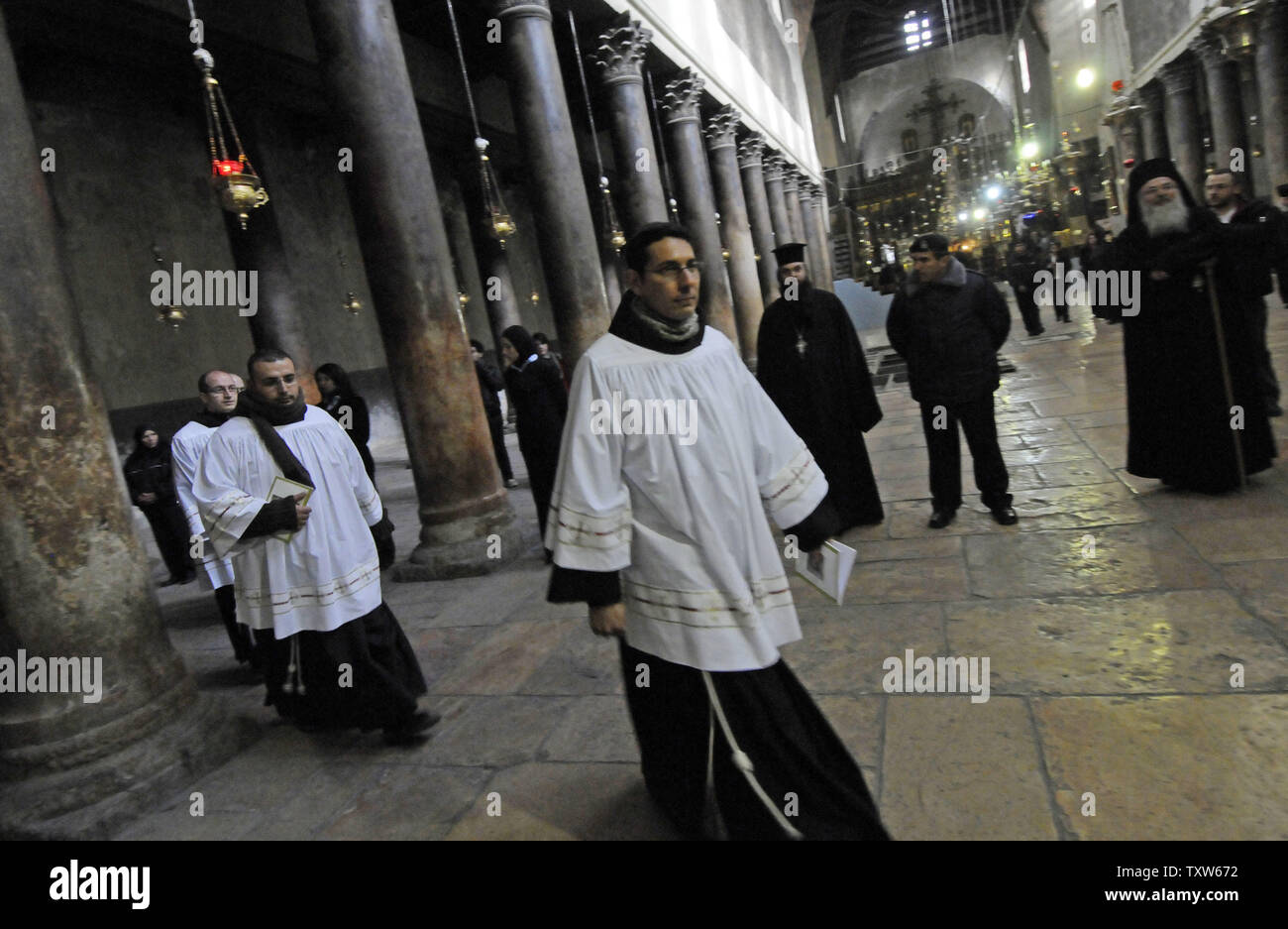 Catholic priests walk in a procession in the Church of Nativity on