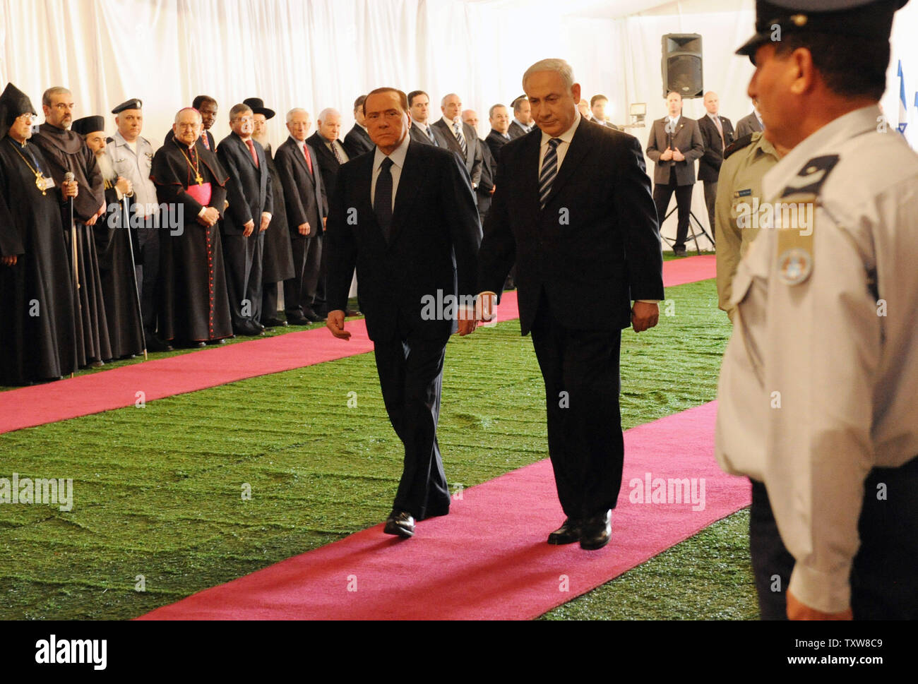 L-R:  Italian Prime Minister Silvio Berlusconi and Israeli Prime Minister Benjamin Netanyahu walk on the red carpet at a welcoming ceremony at Netanyahu's Jerusalem office, February 1, 2010. Prime Minister Berlusconi is in Israel for a three- day visit.   UPI/Debbie Hill Stock Photo