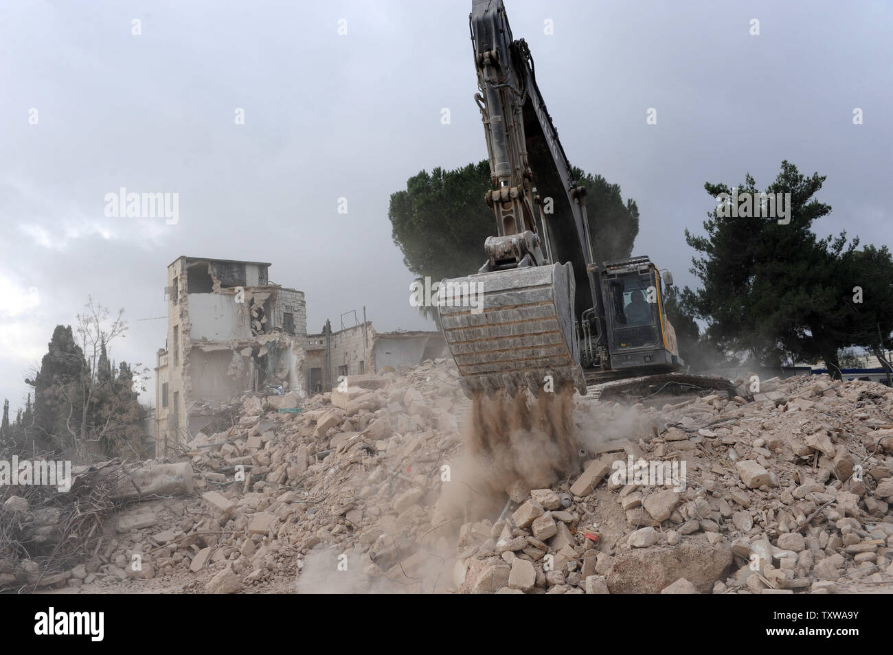 Israeli bulldozers demolish the Shepherd Hotel in the East Jerusalem ...