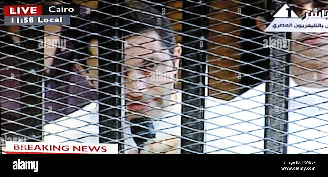 Video image taken from Egyptian State Television shows Alaa Mubarak, son of Hosni Mubarak, speaking on a microphone inside a cage in a Cairo courtroom, August 3, 2011. Mubarak and his two sons, Alaa and Gamal, are being tried on charges of corruption and ordering the killing of protesters during the revolution that ended his reign after 18 days of popular protest. UPI/Debbie Hill Stock Photo