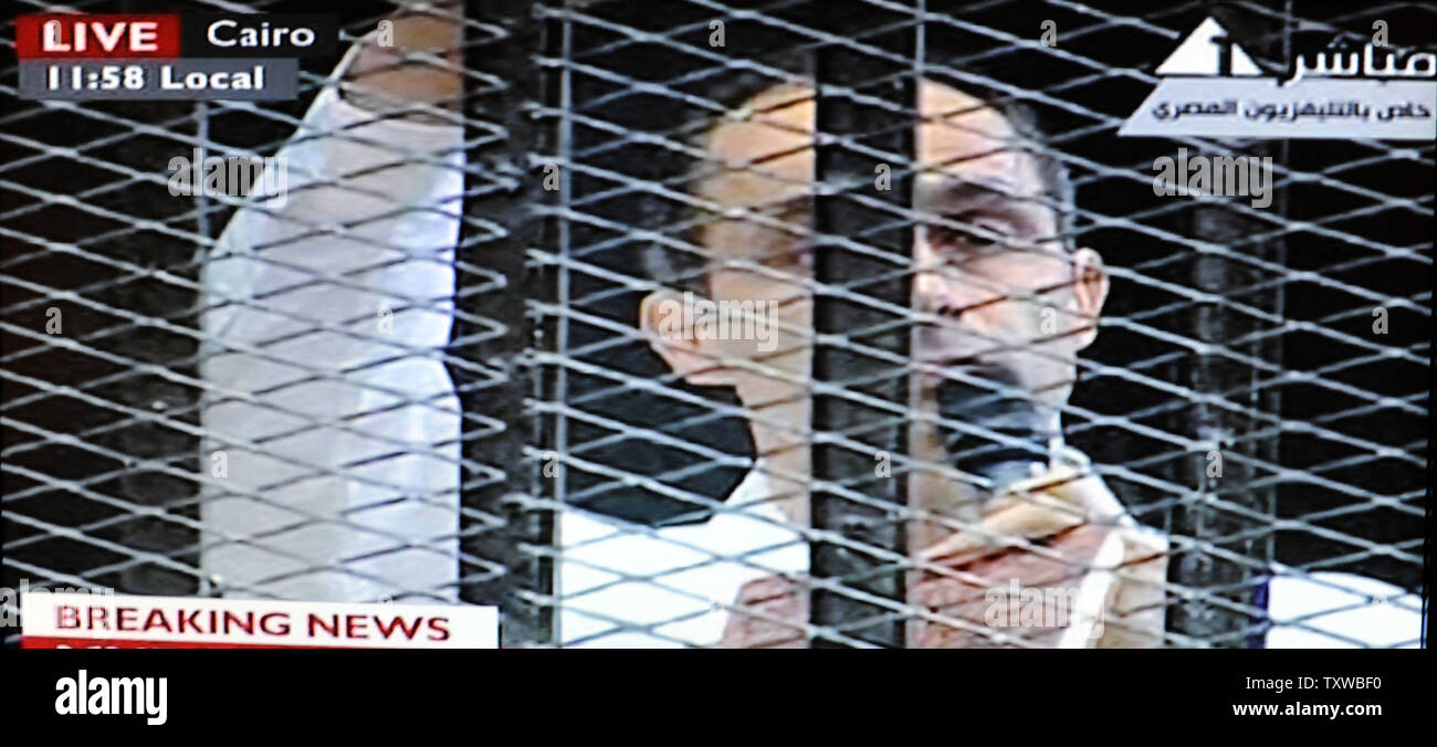 Video image taken from Egyptian State Television shows Gamal Mubarak, son of Hosni Mubarak, speaking on a microphone inside a cage in a Cairo courtroom, August 3, 2011. Mubarak and his two sons, Alaa and Gamal, are being tried on charges of corruption and ordering the killing of protesters during the revolution that ended his reign after 18 days of popular protest. UPI/Debbie Hill Stock Photo