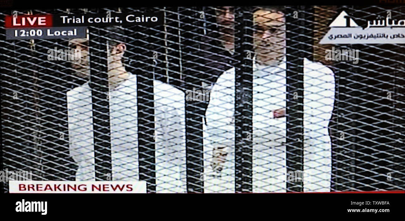 Video image taken from Egyptian State Television shows Alaa Mubarak, L, and Gamal Mubarak, R, sons of Hosni Mubarak,  inside a cage in a Cairo courtroom, August 3, 2011. Mubarak and his two sons, Alaa and Gamal, are being tried on charges of corruption and ordering the killing of protesters during the revolution that ended his reign after 18 days of popular protest. UPI/Debbie Hill Stock Photo