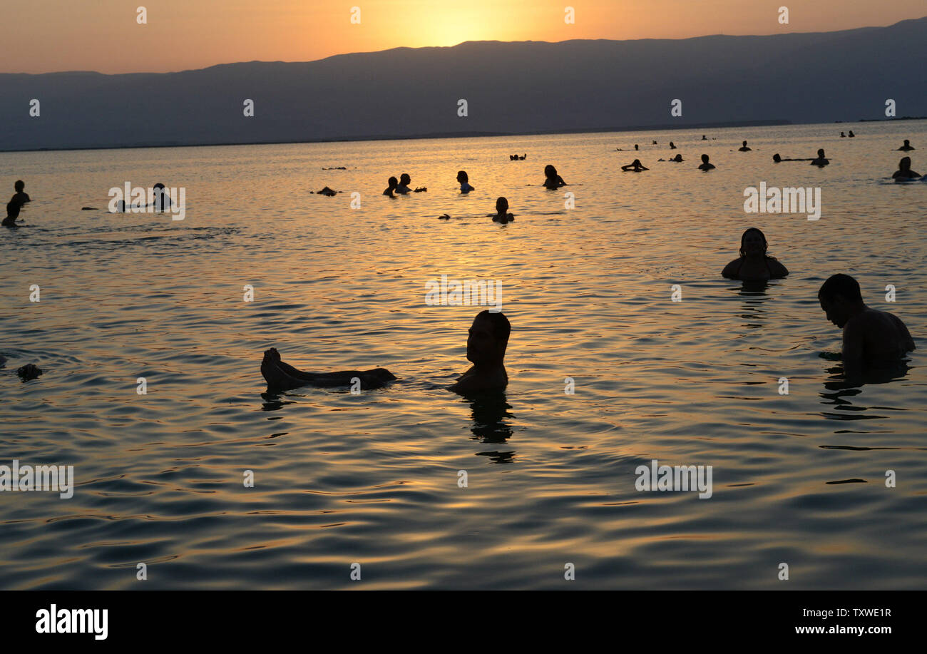 Israeli and international environmental and social activists participate in a protest float in the Dead Sea, at dawn against the deterioration of the Dead Sea, in an event organized by U.S. photographer Spencer Tunick, not seen, at Ein Bokek, Israel, September 14, 2012. UPI/Debbie Hill Stock Photo