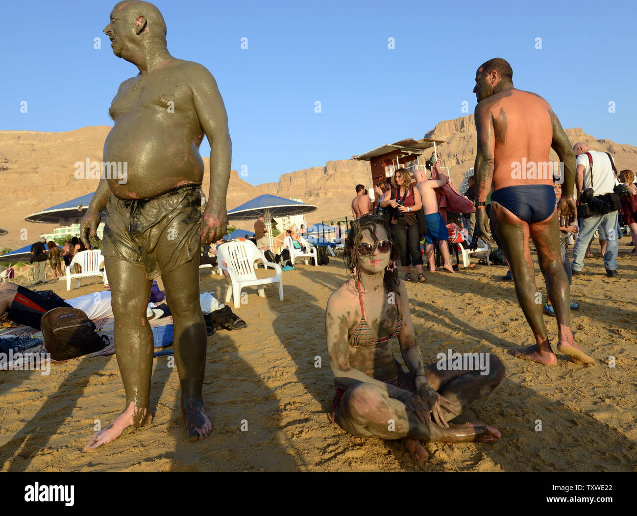 Israeli and international environmental and social activists wear black mud from the Dead Sea during a protest float at dawn against the deterioration of the Dead Sea, in an event organized by U.S. photographer Spencer Tunick, not seen, at Ein Bokek, Israel, September 14, 2012. UPI/Debbie Hill Stock Photo