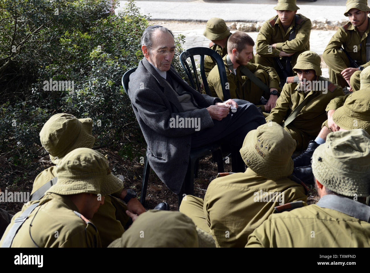 Holocaust survivor Meir Friedmann, 87, shares his personal testimony with Israeli combat soldiers during a Holocaust commemoration event on Holocaust Martyrs' and Heroes' Remembrance Day, in the Martyr's Forest "Scroll of Fire", outside of Jerusalem, Israel, April 8, 2013.  UPI/Debbie Hill Stock Photo